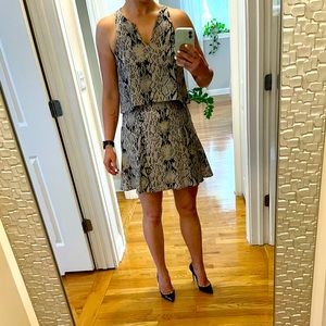 Short silk dress by Parker. The top part has a peplum effect.